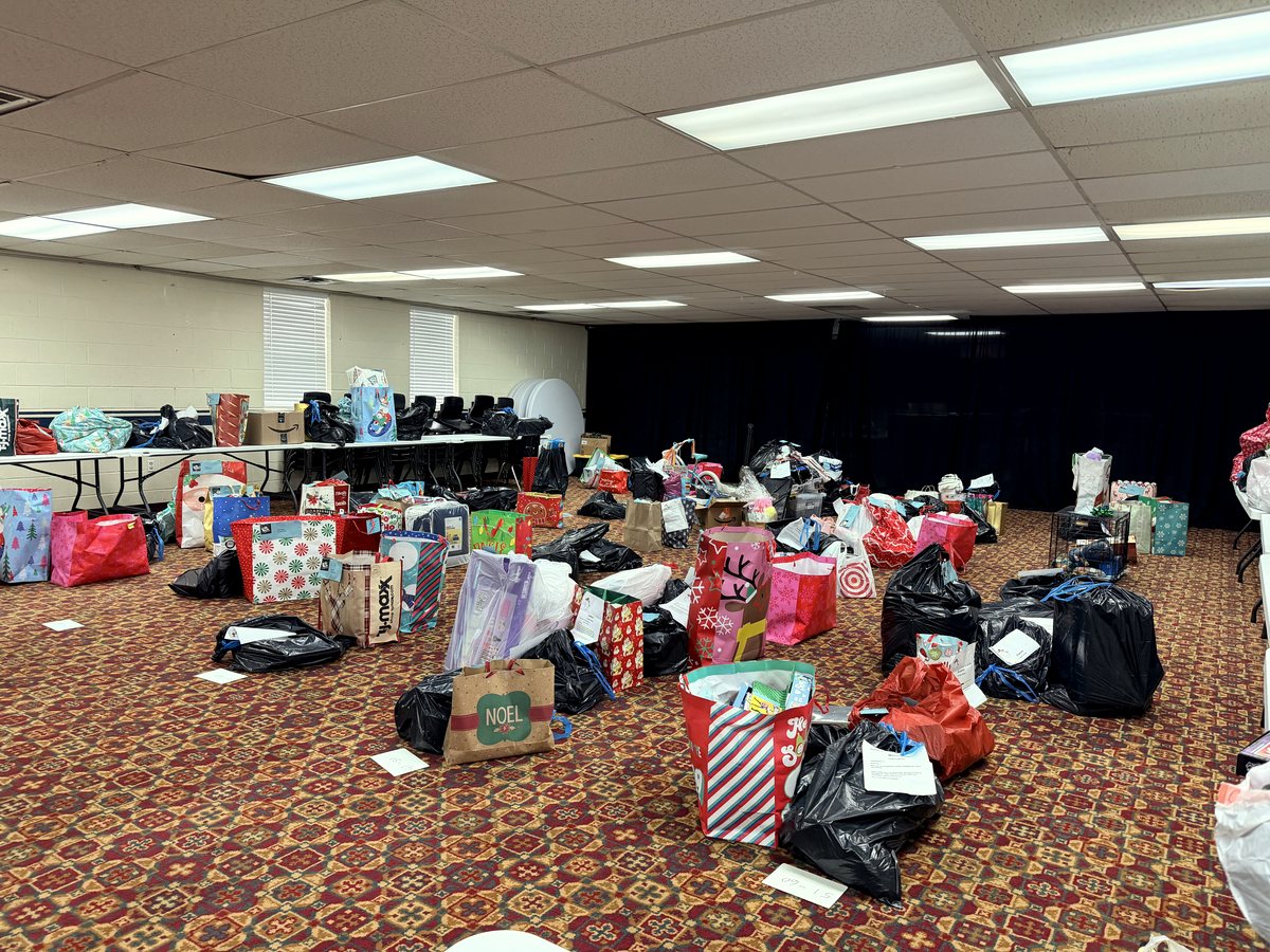 A room filled with tagged Christmas gift bags ready for distribution