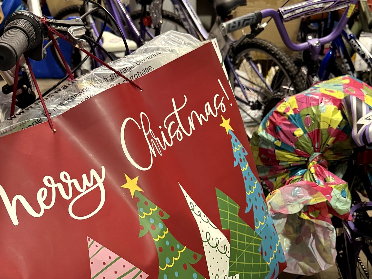 Bicycles and wrapped gifts in the Project Noelle storeroom