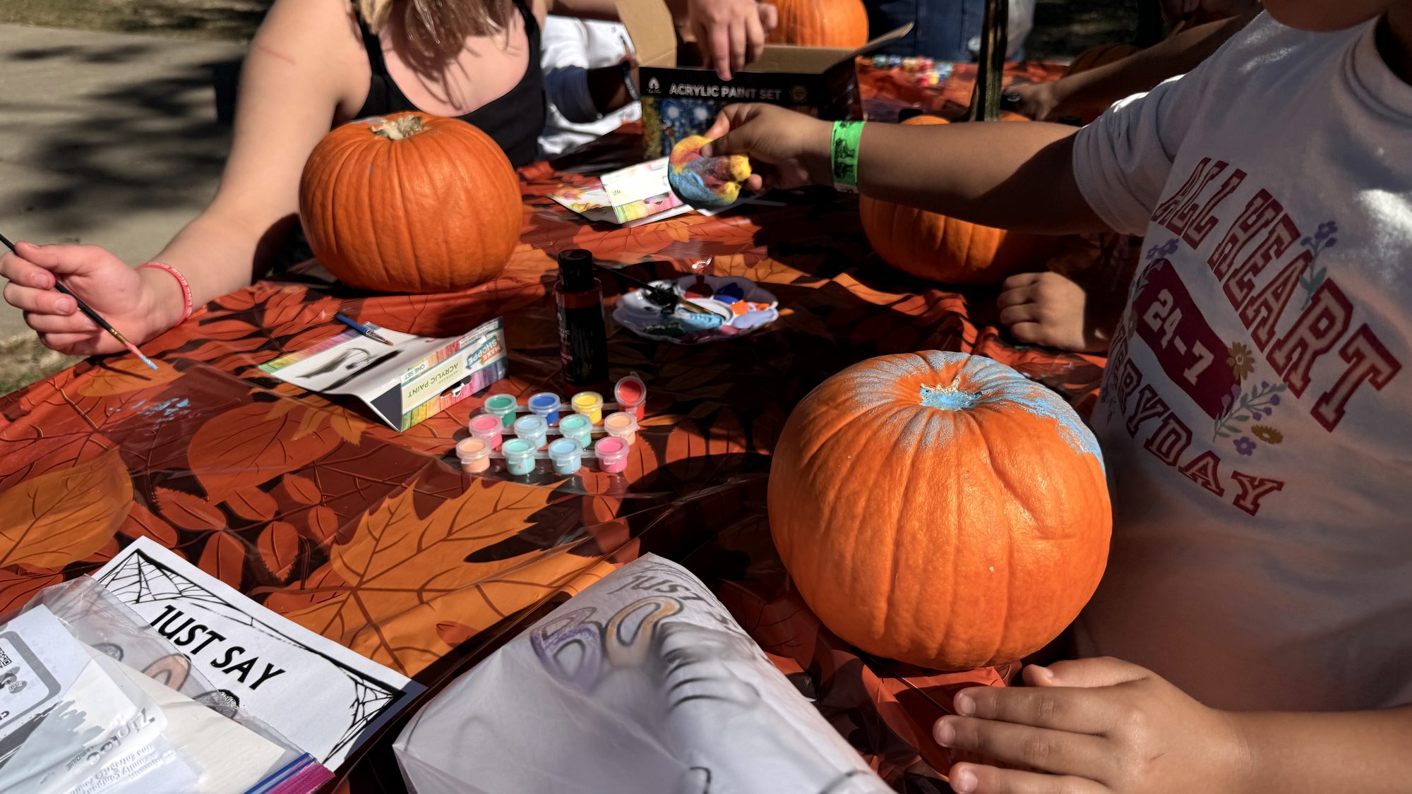 Children painting pumpkins at a Red Ribbon Spooktacular
